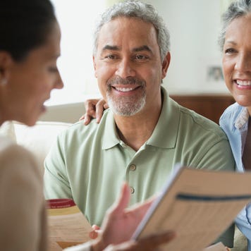 Saleswoman talking to clients in living room