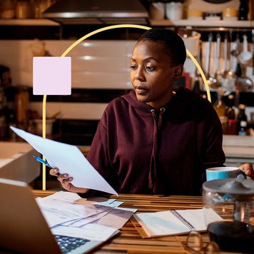 capital gains tax on real estate - woman looking at financial paperwork at home