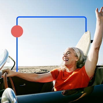 Older person driving a convertible and enjoying the breeze