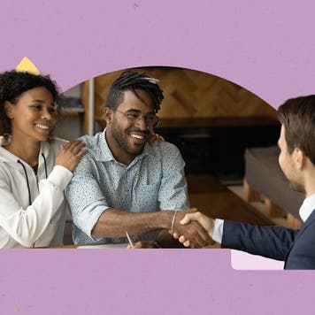 couple shaking hands with business man