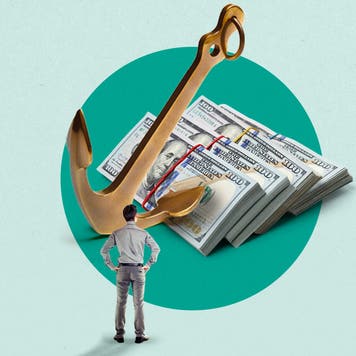 A man looking at a comically large stack of cash