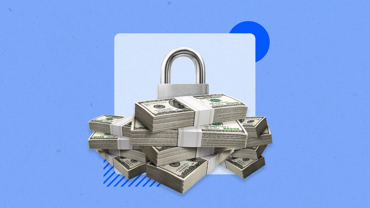A large pile of cash next to a padlock