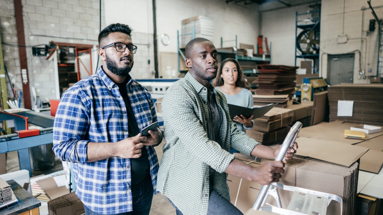 Three business owners review documents.