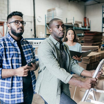 Three business owners review documents.