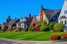 Photo of a row of historic home exteriors on a sunny spring day with clear blue sky