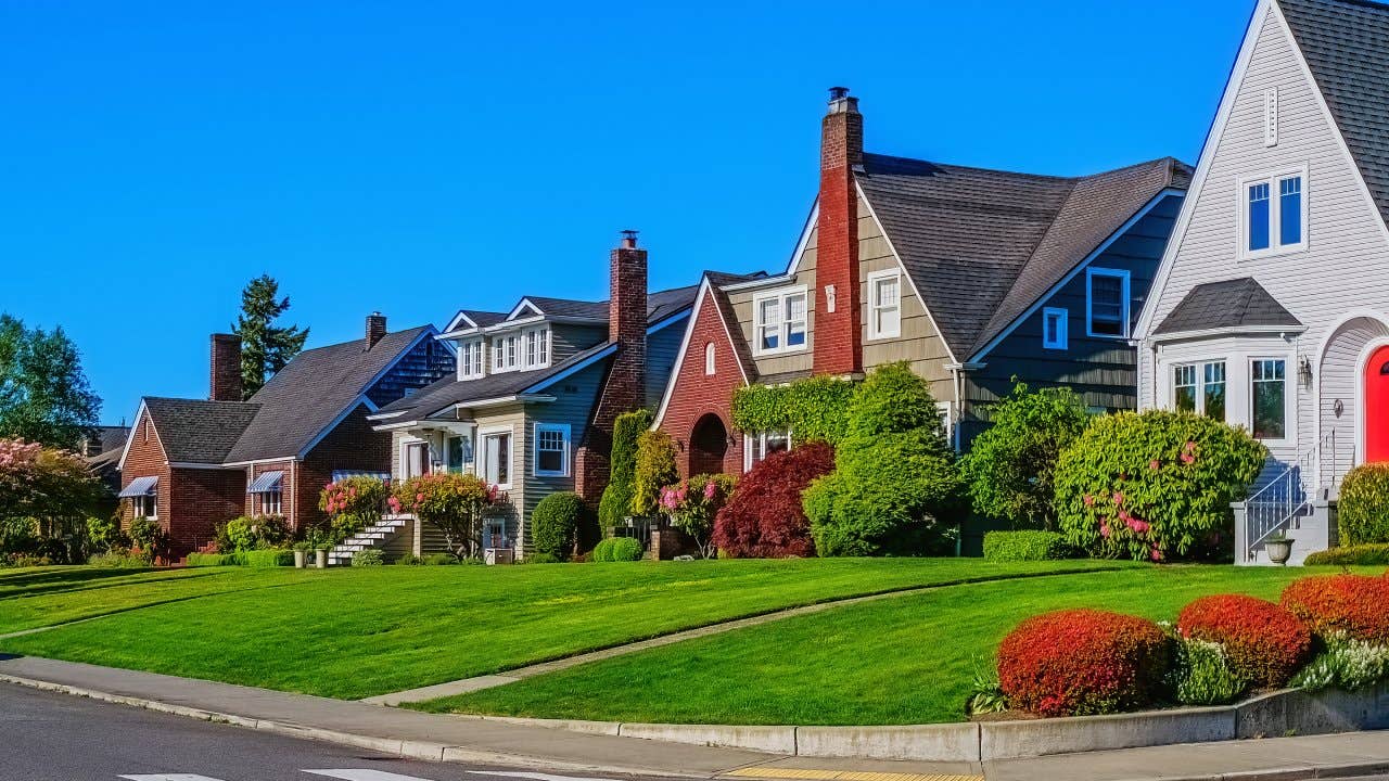 Photo of a row of historic home exteriors on a sunny spring day with clear blue sky