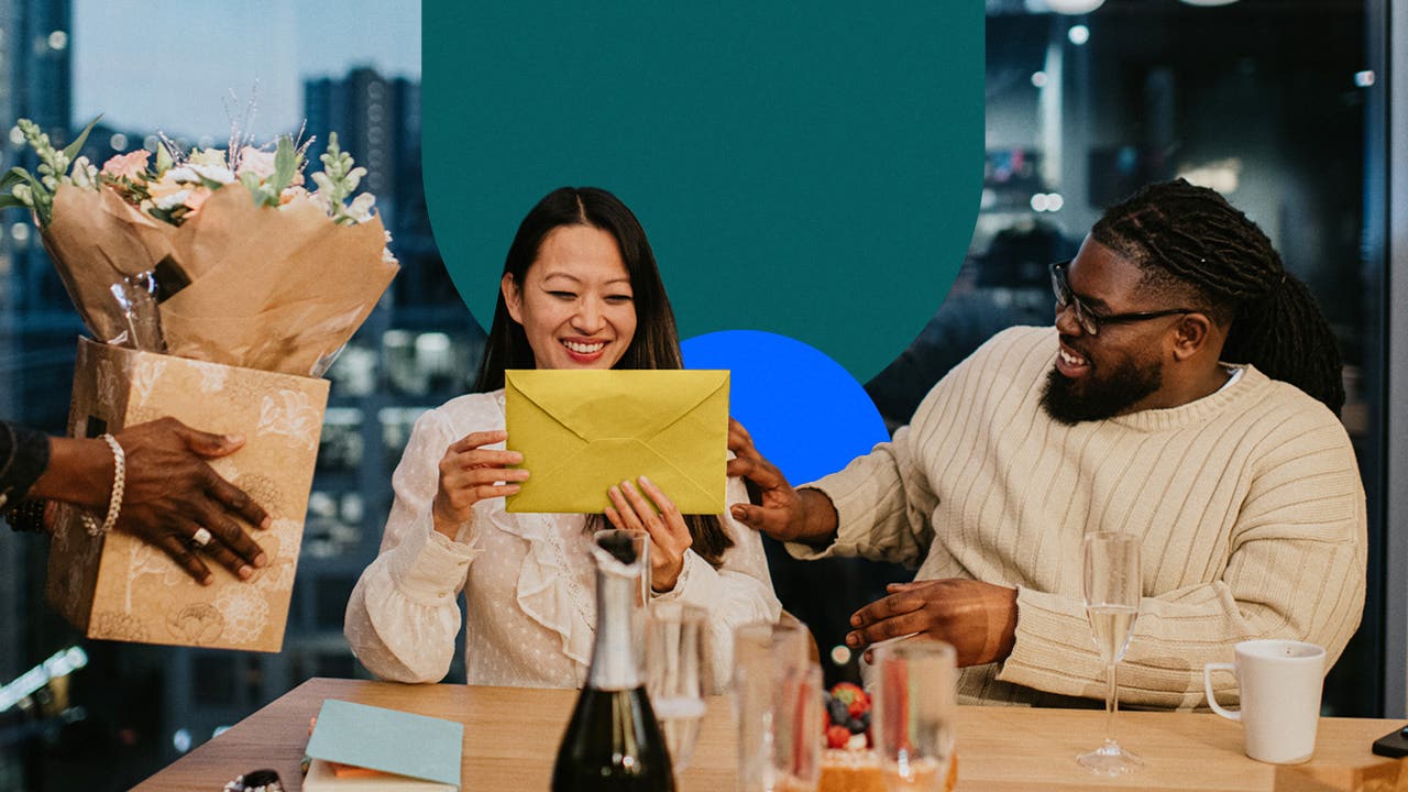 A happy woman opening presents in front of people