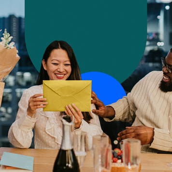 A happy woman opening presents in front of people