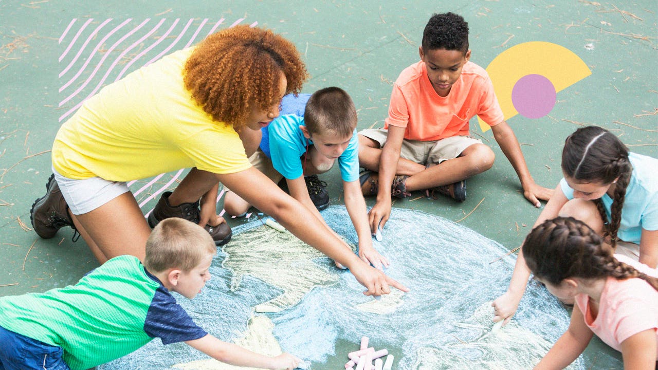 A teacher and children drawing the globe in chalk