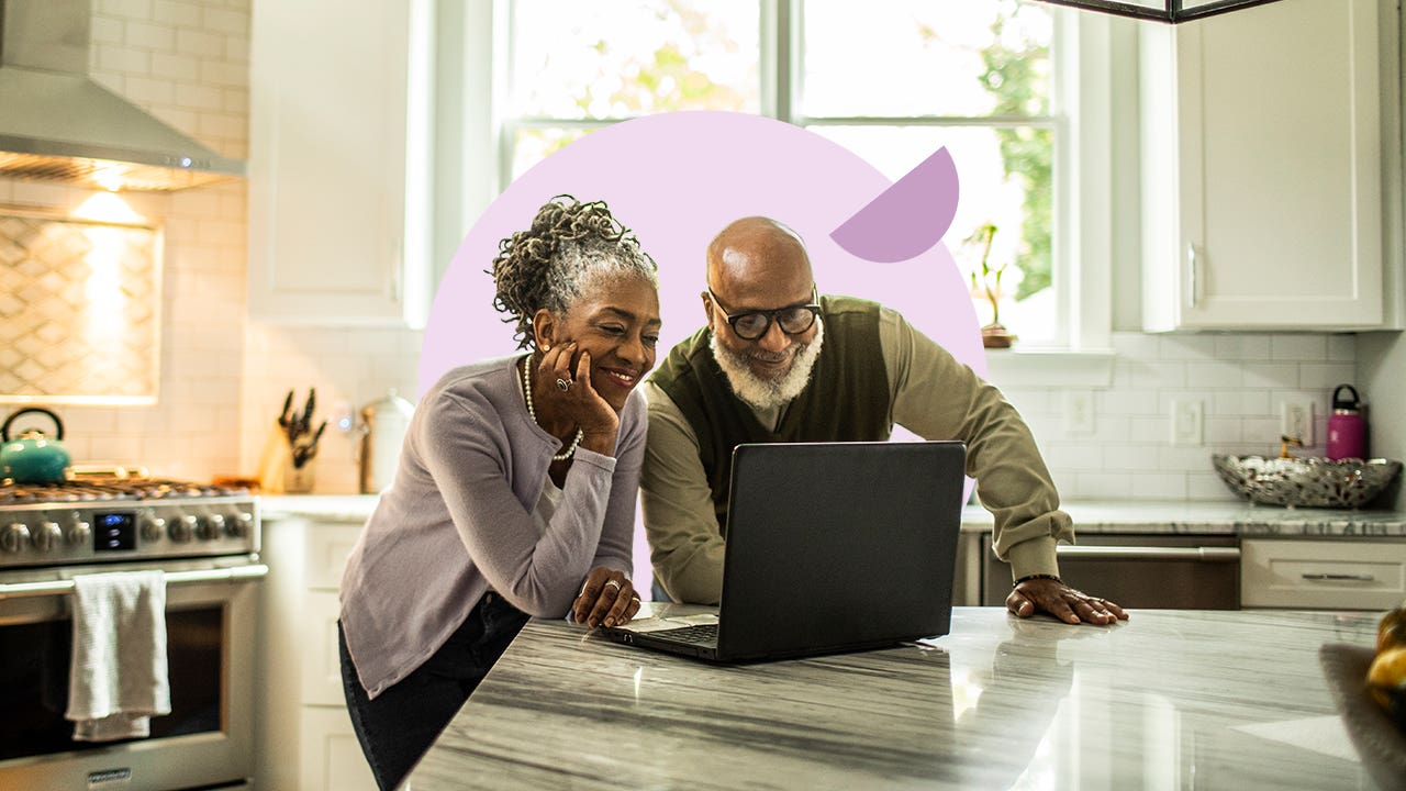 Senior couple looking at a laptop