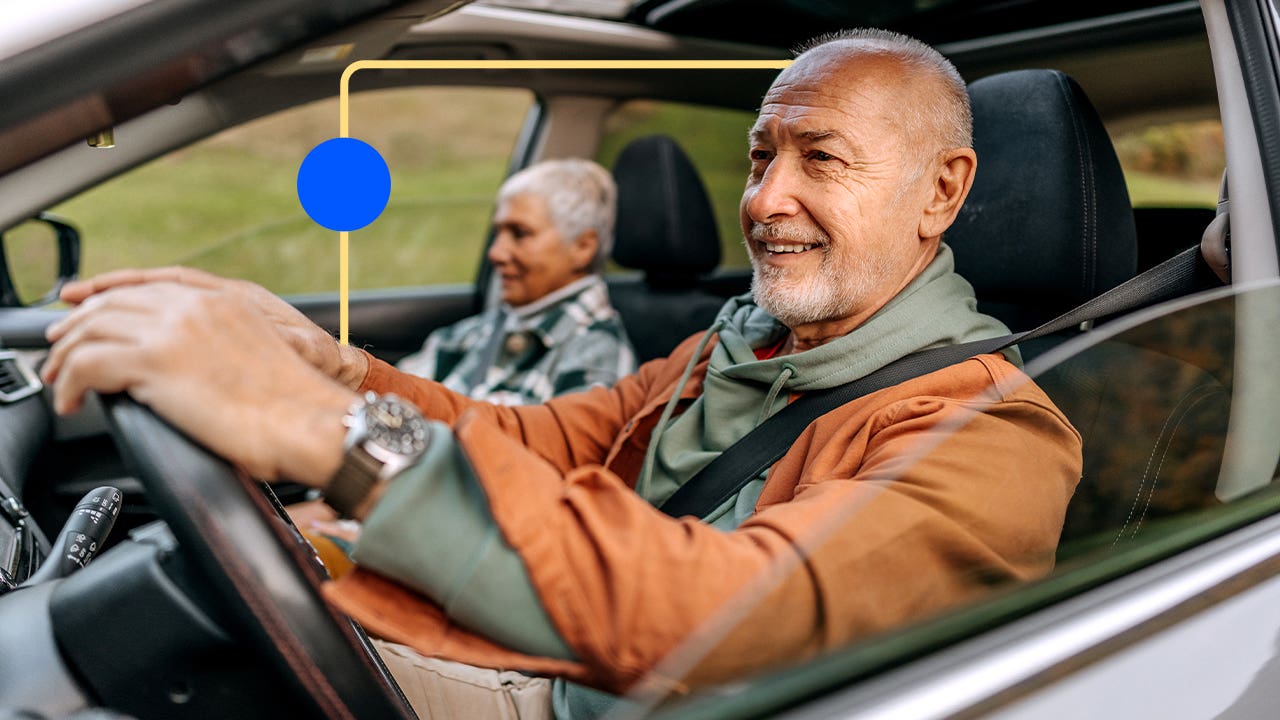 Older couple driving and enjoying the scenery