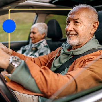 Older couple driving and enjoying the scenery