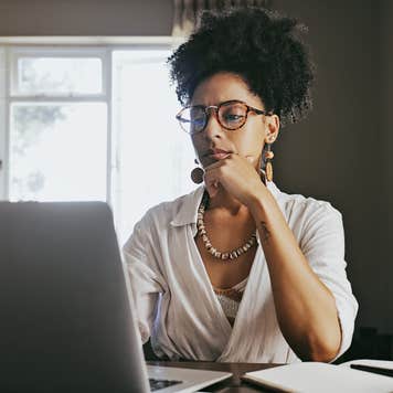 Young woman comparing lenders on laptop