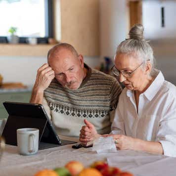 Senior couple sitting at the kitchen table