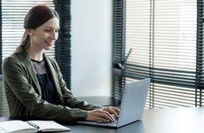 Young business woman working at the office on a laptop