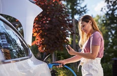 Woman charging electric car