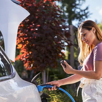 Woman charging electric car