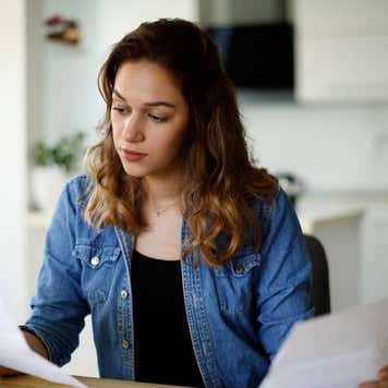 Serious young woman working at home