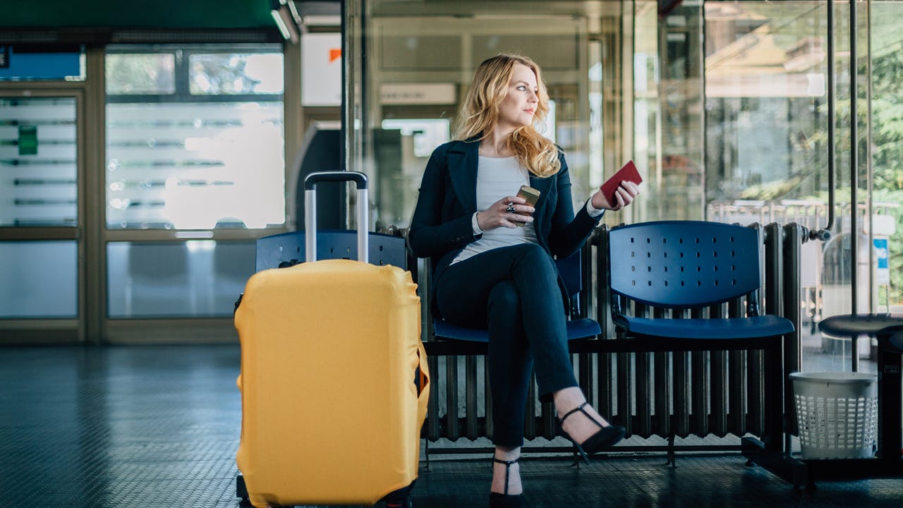 Businesswoman waiting for her flight at the airport