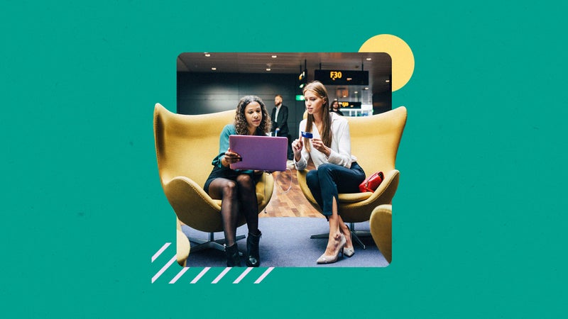 design element including two women sitting down in chairs and discussing while looking at a laptop
