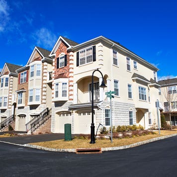 deed restricted property - suburban row houses with blue sky