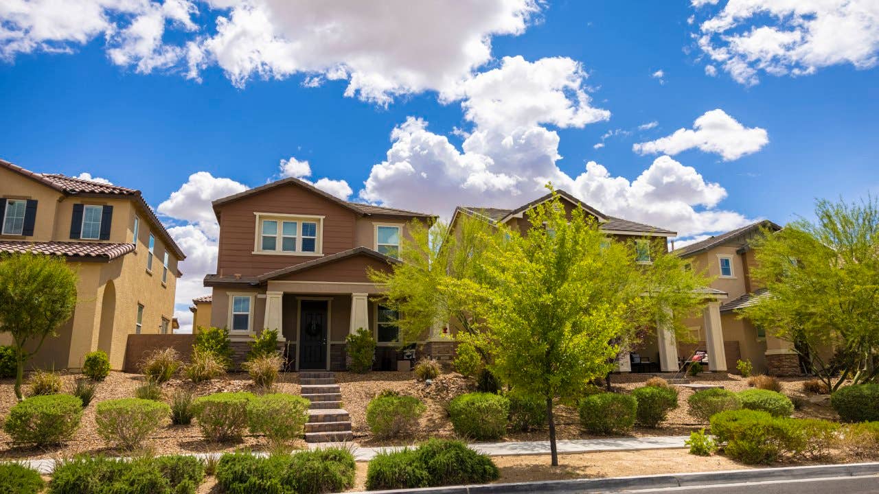 A nice neighborhood in the Las Vegas, Nevada area. Showing lush green plants and trees with modern new homes.