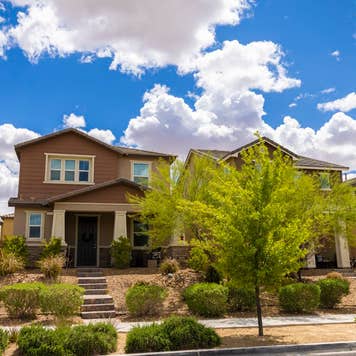 A nice neighborhood in the Las Vegas, Nevada area. Showing lush green plants and trees with modern new homes.