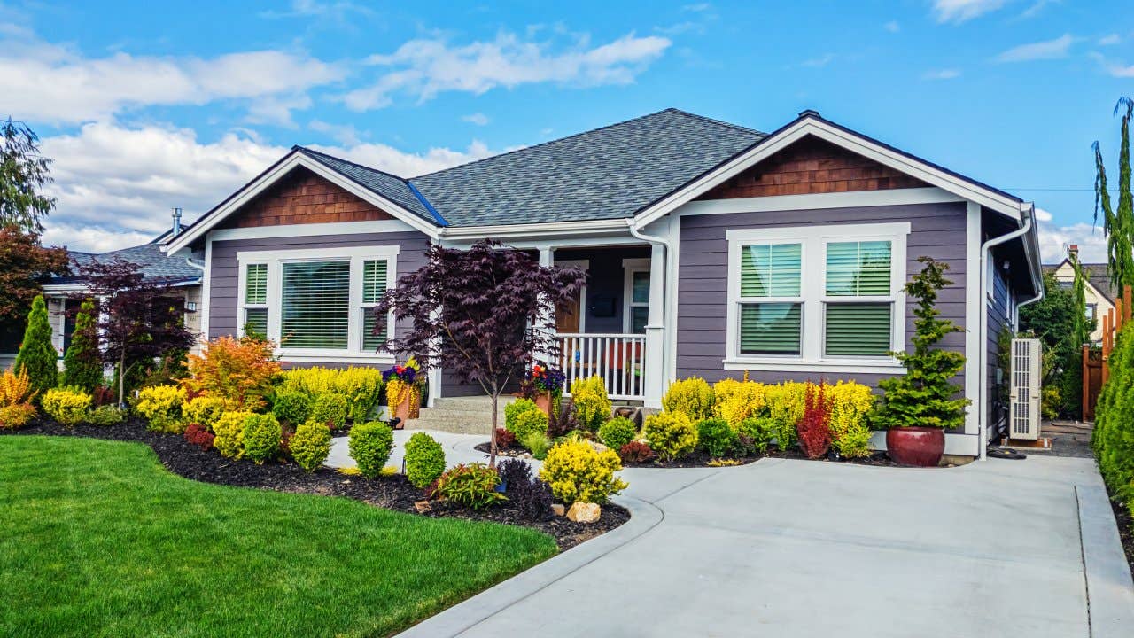 Photo of a modern custom single-level suburban home on a sunny summer day