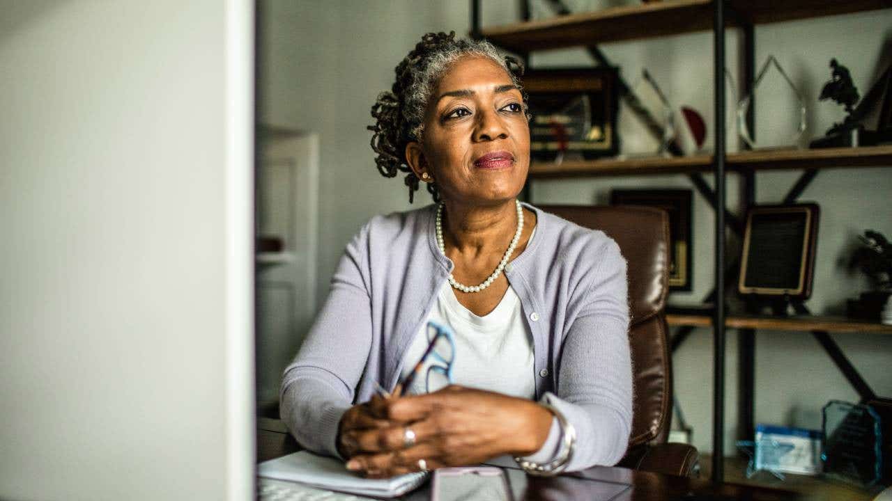 senior woman at desktop computer in home office