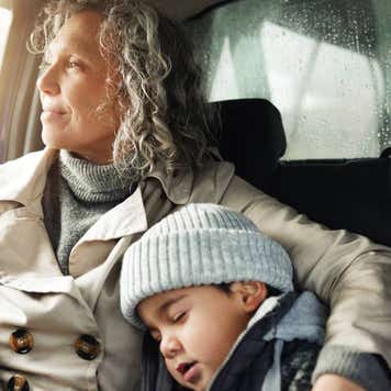 sleeping child and grandma rest on travel adventure for family bonding