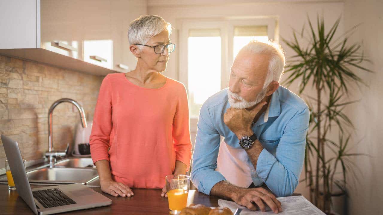 senior couple spending time together but apart during a breakfast in a morning