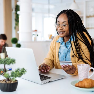 Woman at home, working on laptop