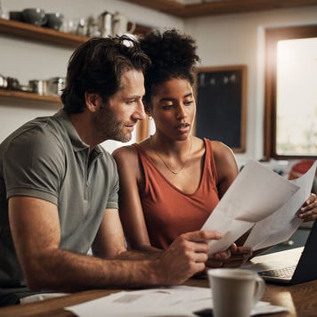 is 700 a good credit score to buy a house - couple doing budget in kitchen