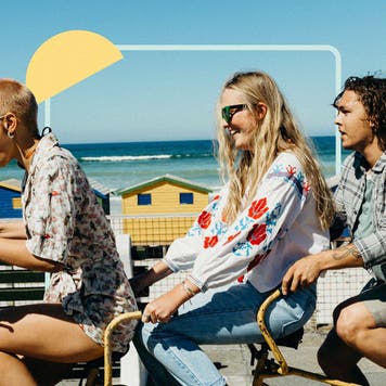 3 adults riding a multiple person bike