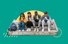 Four young people sitting on cement steps and looking at their cell phones