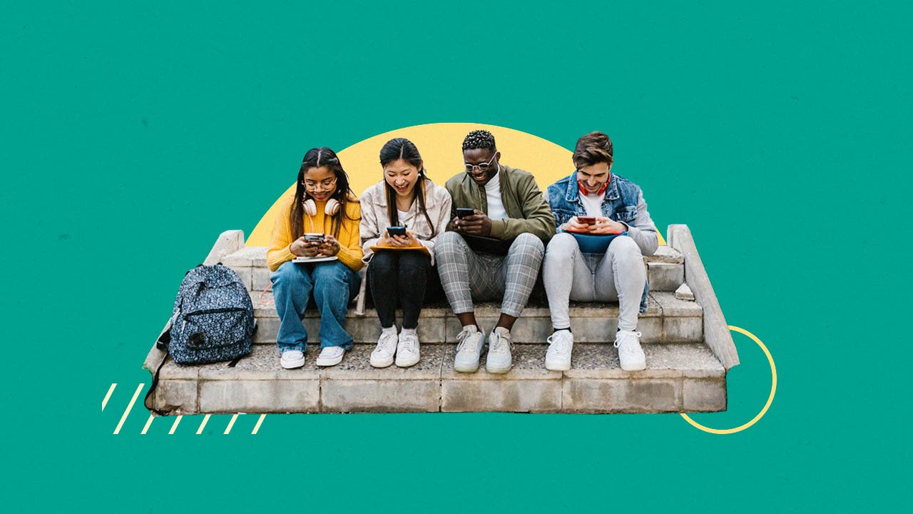 Four young people sitting on cement steps and looking at their cell phones