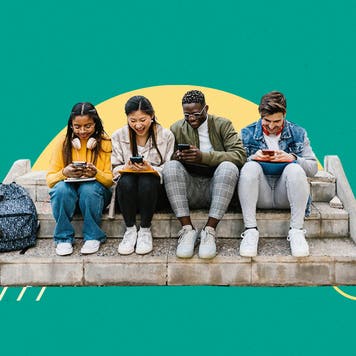 Four young people sitting on cement steps and looking at their cell phones