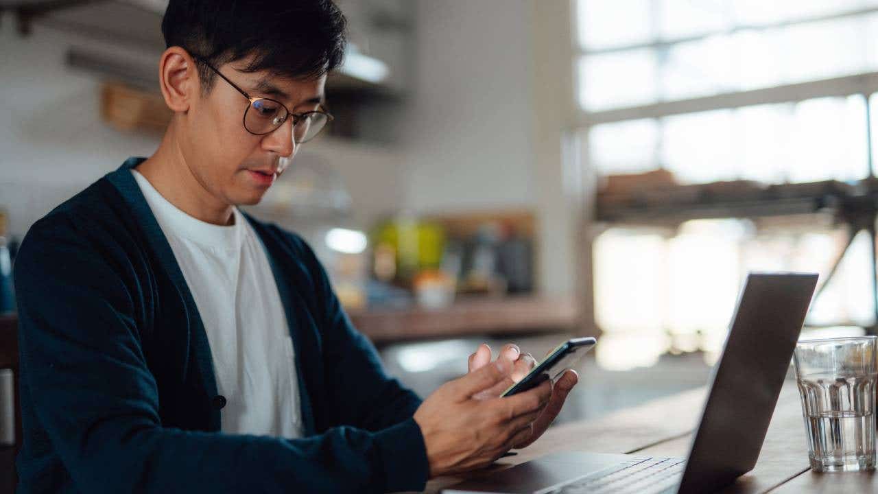 adult student learning computer language on laptop and smart phone