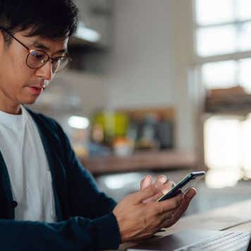 adult student learning computer language on laptop and smart phone