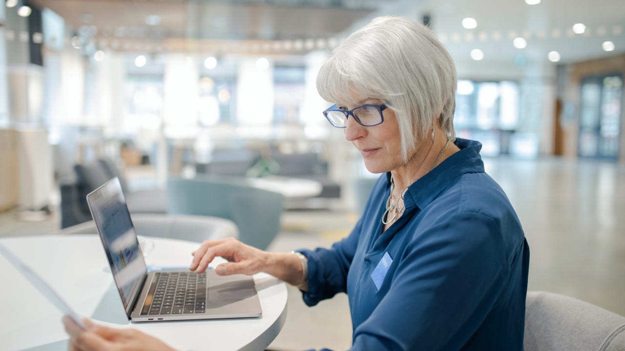 Female working at laptop in bank branch