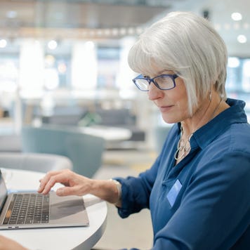 Female working at laptop in bank branch