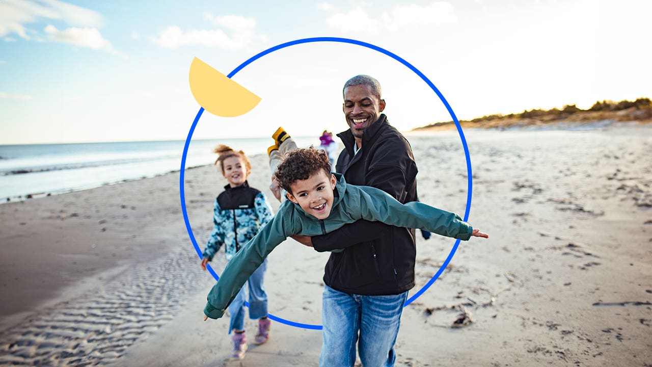 Father holding his child and spinning him around and playing pretend airplane