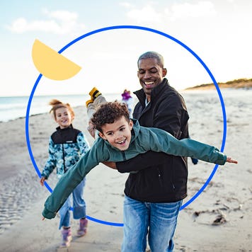 Father holding his child and spinning him around and playing pretend airplane