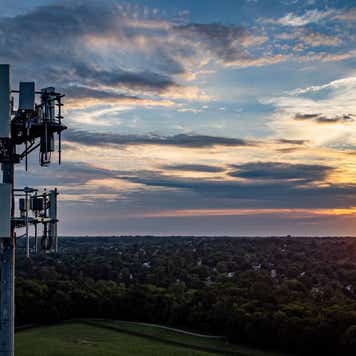 5G mobile cell phone repeater tower on the hill of a park