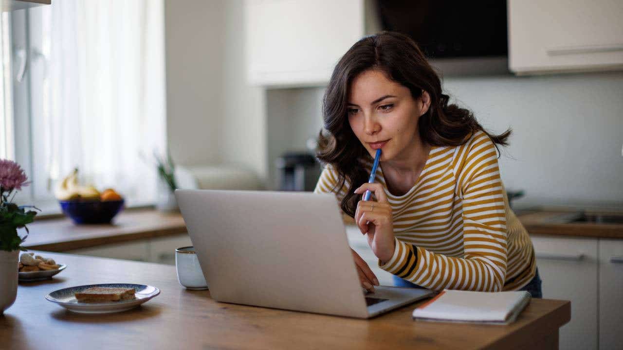 Young woman using a laptop while working from home