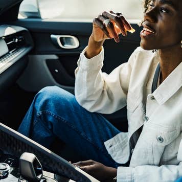 Woman having candy sitting with friend in car