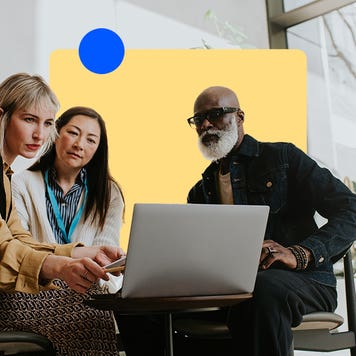 A financial advisor with a pair of clients gathered around their computer
