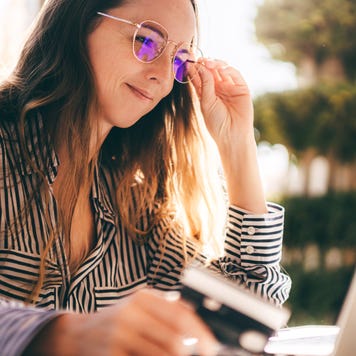 Beautiful businesswoman is working on the laptop, making online purchases with a card