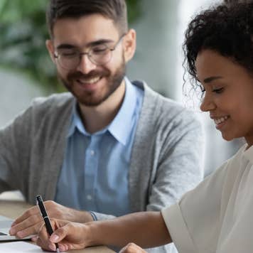 happy couple signing papers