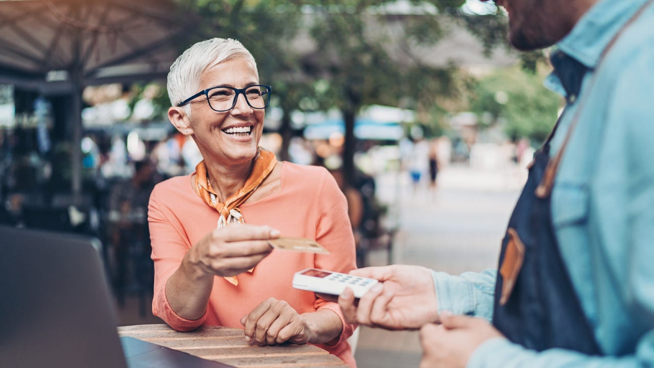 Senior woman paying with a credit card